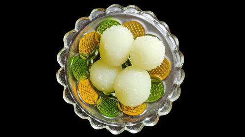 Close-up of water drops on fruit against black background