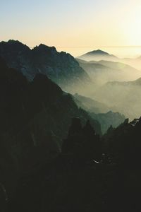 Scenic view of silhouette mountains against sky during sunset