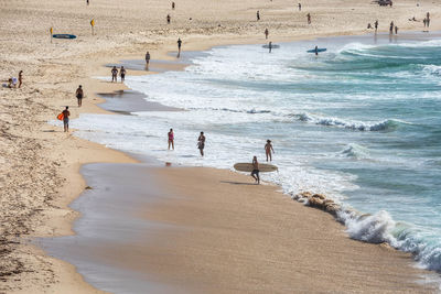 Surfers and swimmers at bondi beach