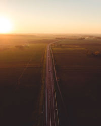 Scenic view of road against clear sky during sunset