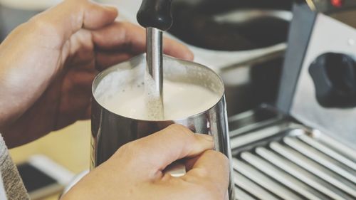 Close-up of hand holding coffee cup