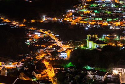 High angle view of illuminated buildings in city at night