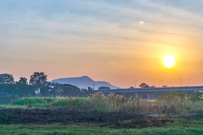 Scenic view of field against sky during sunset