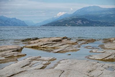 Scenic view of lake and mountains against sky