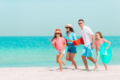 Family running on beach