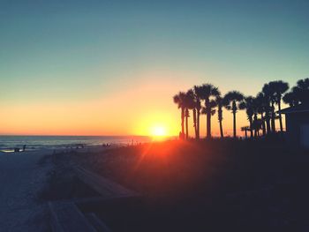 Scenic view of sea against clear sky during sunset