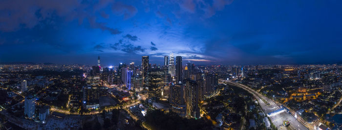 High angle view of city lit up at night