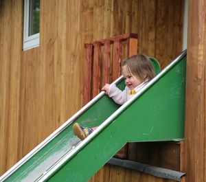 Rear view of a girl on wooden table