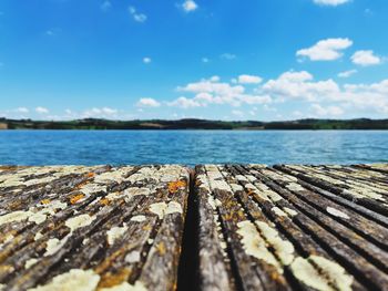 Surface level of pier over sea against sky