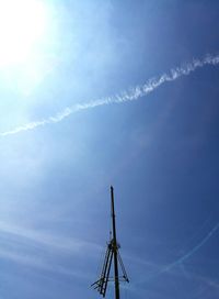 Low angle view of vapor trail against blue sky