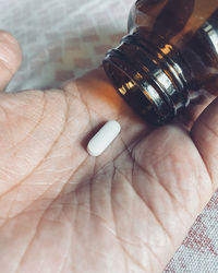 Close-up of hand holding bottle