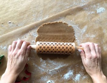 Cropped image of hand making cookies