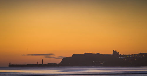 Scenic view of sea against romantic sky at sunset whitby sunrise