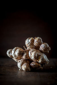 Close-up of bread on table against black background