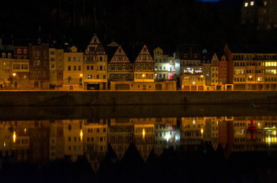 Reflection of buildings in city at night