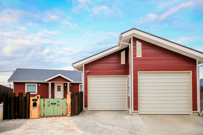 Exterior of house by building against sky