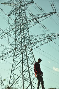 Low angle view of electricity pylon against sky