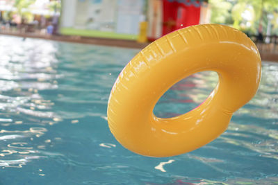 Close-up of yellow floating in swimming pool