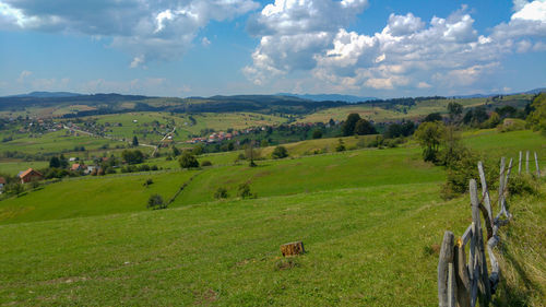 Scenic view of green landscape against sky