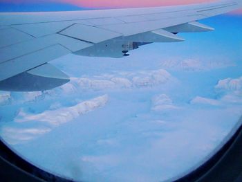 Cropped image of airplane wing over landscape