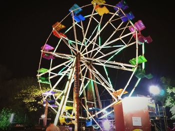 Low angle view of illuminated ferris wheel