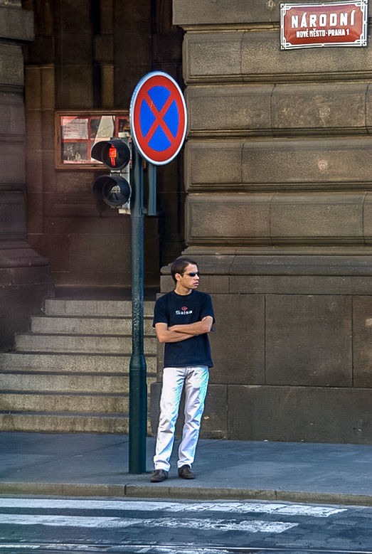 one person, real people, architecture, casual clothing, lifestyles, standing, young adult, full length, sign, leisure activity, building exterior, built structure, front view, young men, communication, city, adult, arms crossed, outdoors