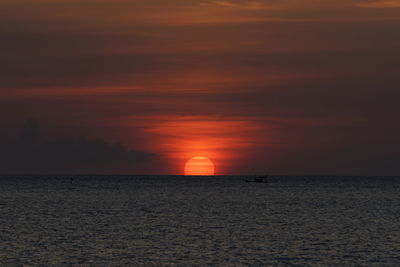 Scenic view of sea against orange sky