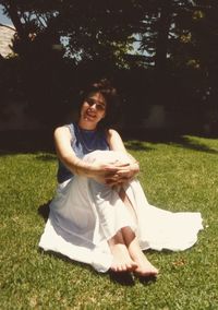 Smiling young woman sitting on grass