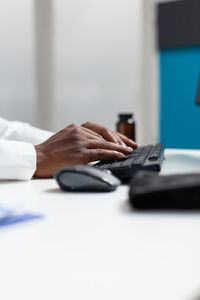 Close-up of cropped hands typing