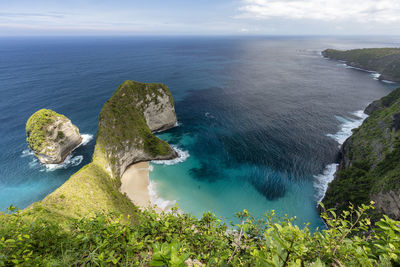 High angle view of rocks by sea against sky