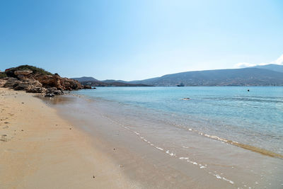 Scenic view of beach against blue sky