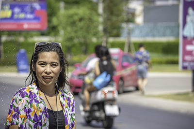 Portrait of a smiling young woman in city