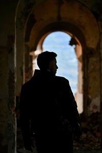 Silhouette man looking at historic building