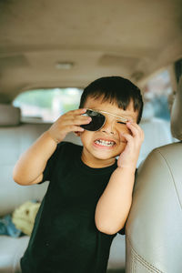 Portrait of young woman in car
