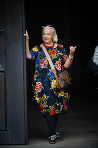 Portrait of woman standing against the wall