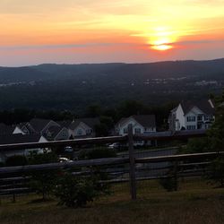 Built structure on landscape at sunset