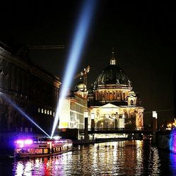 Reflection of illuminated building in water at night