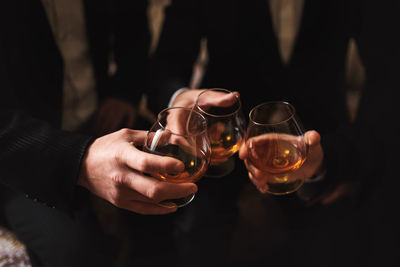 Men with a friend. hold in the hands of glasses of whiskey. close up