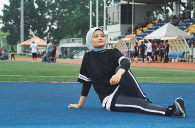 Athlete sitting on running track