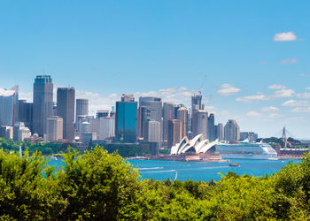 Scenic view of buildings in city against sky