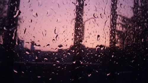 Raindrops on glass window at night