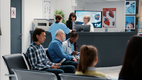 Rear view of business colleagues working in office