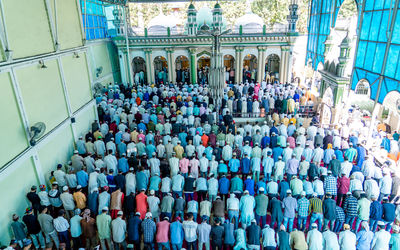 High angle view of people praying in mosque