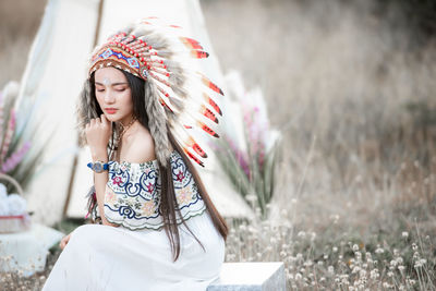 Boho bohemian girl styled wearing indian maxi dress and jewellery in autumn field