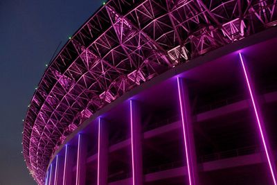 Low angle view of illuminated building against sky at night