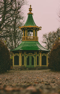 Built structure in park against sky during autumn