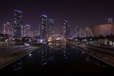 Aerial view of illuminated buildings in city at night