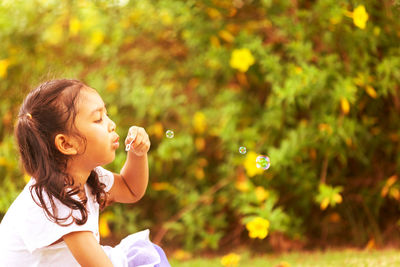 Full length of a girl holding bubbles