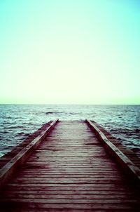 Pier over sea against clear sky