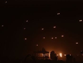 Low angle view of illuminated lights at night